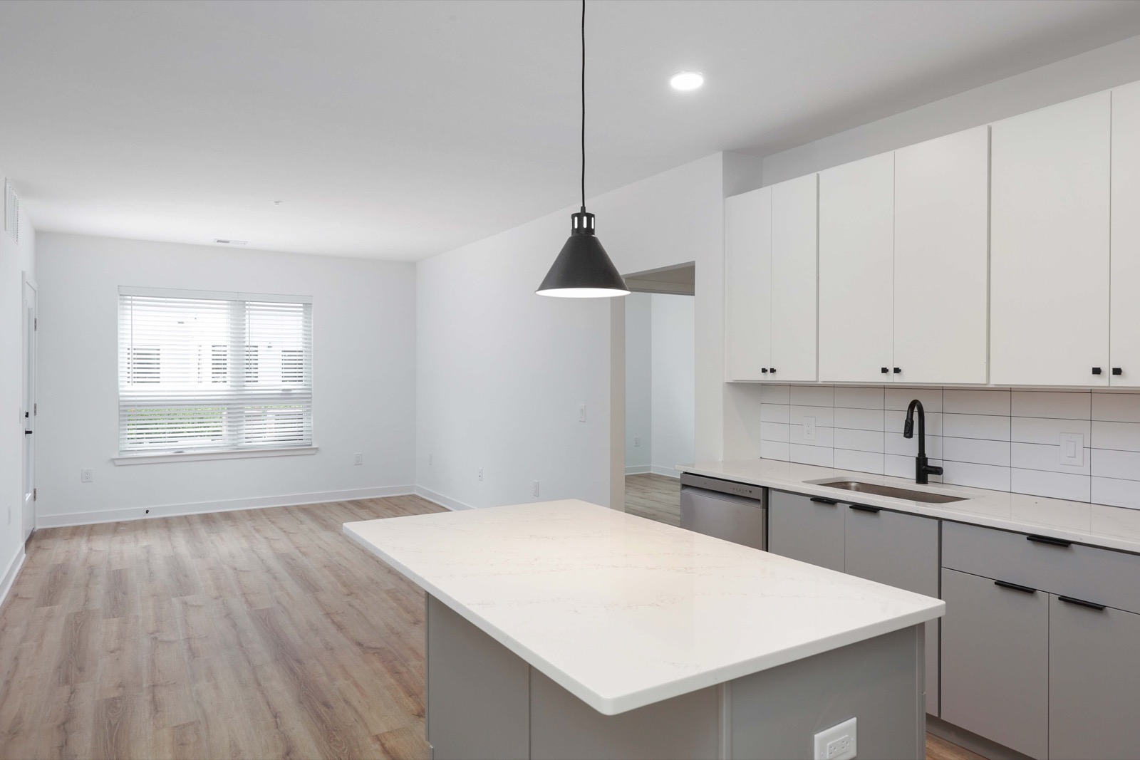 Open floor plan showing kitchen island and living area in a one-bedroom at The Arthur Carteret NJ