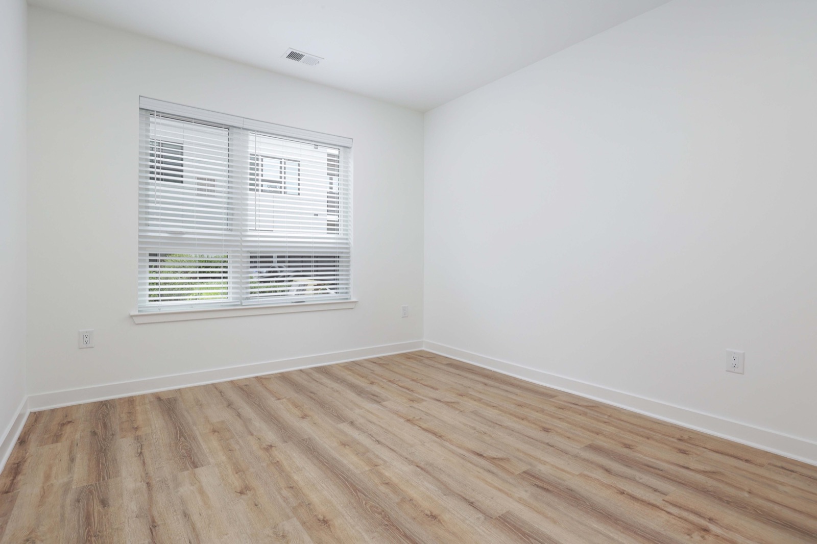 Spacious bedroom with hardwood floors and natural light in a one-bedroom apartment at The Arthur NJ