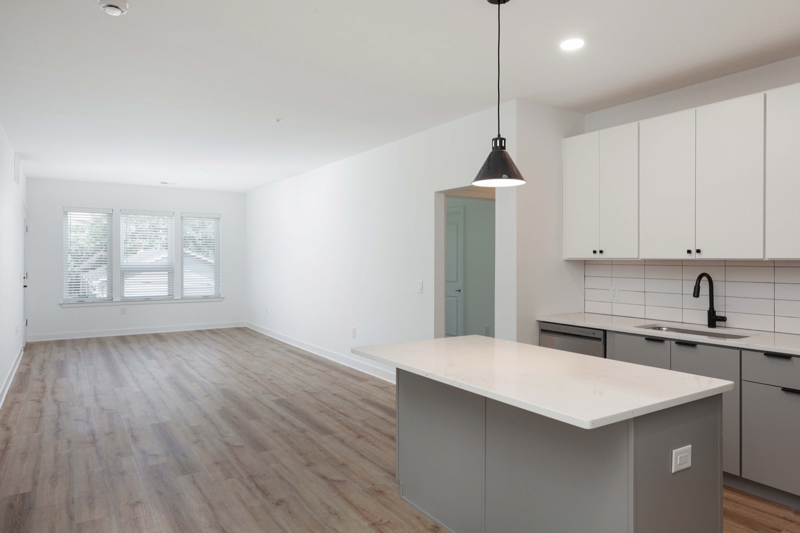 Open floor plan showing kitchen and living area in a 2BR apartment at The Arthur in Carteret NJ