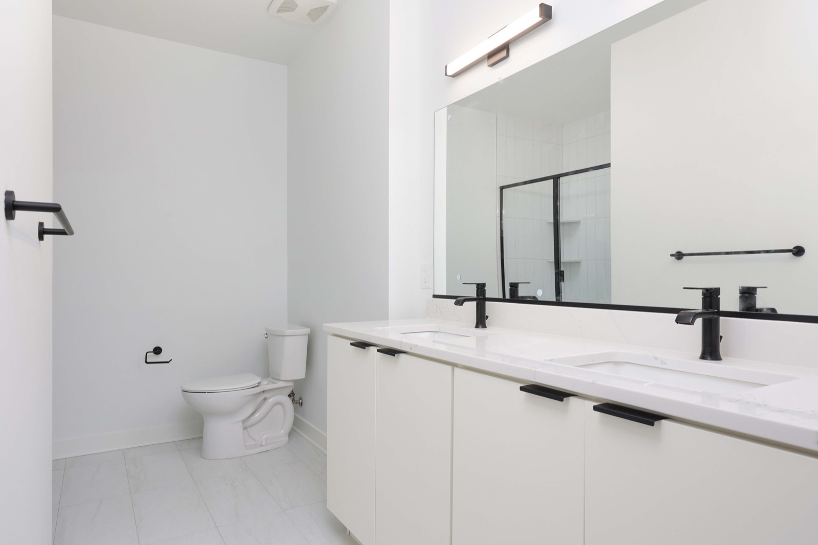 Primary bathroom with double vanity in a two-bedroom apartment at The Arthur Carteret NJ