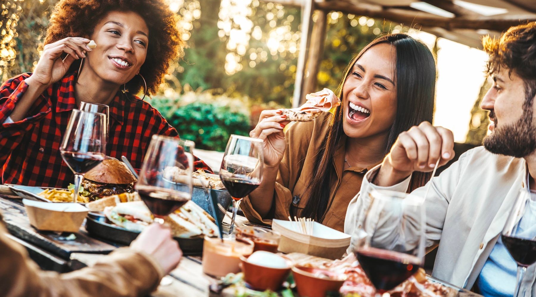 a group of people laughing and eating