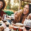 a group of people laughing and eating