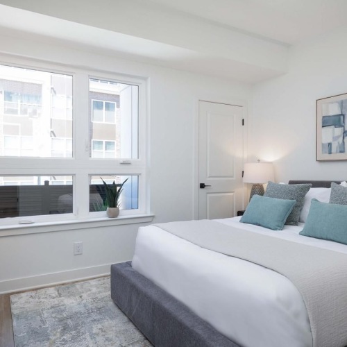 a bedroom with a bed and a window