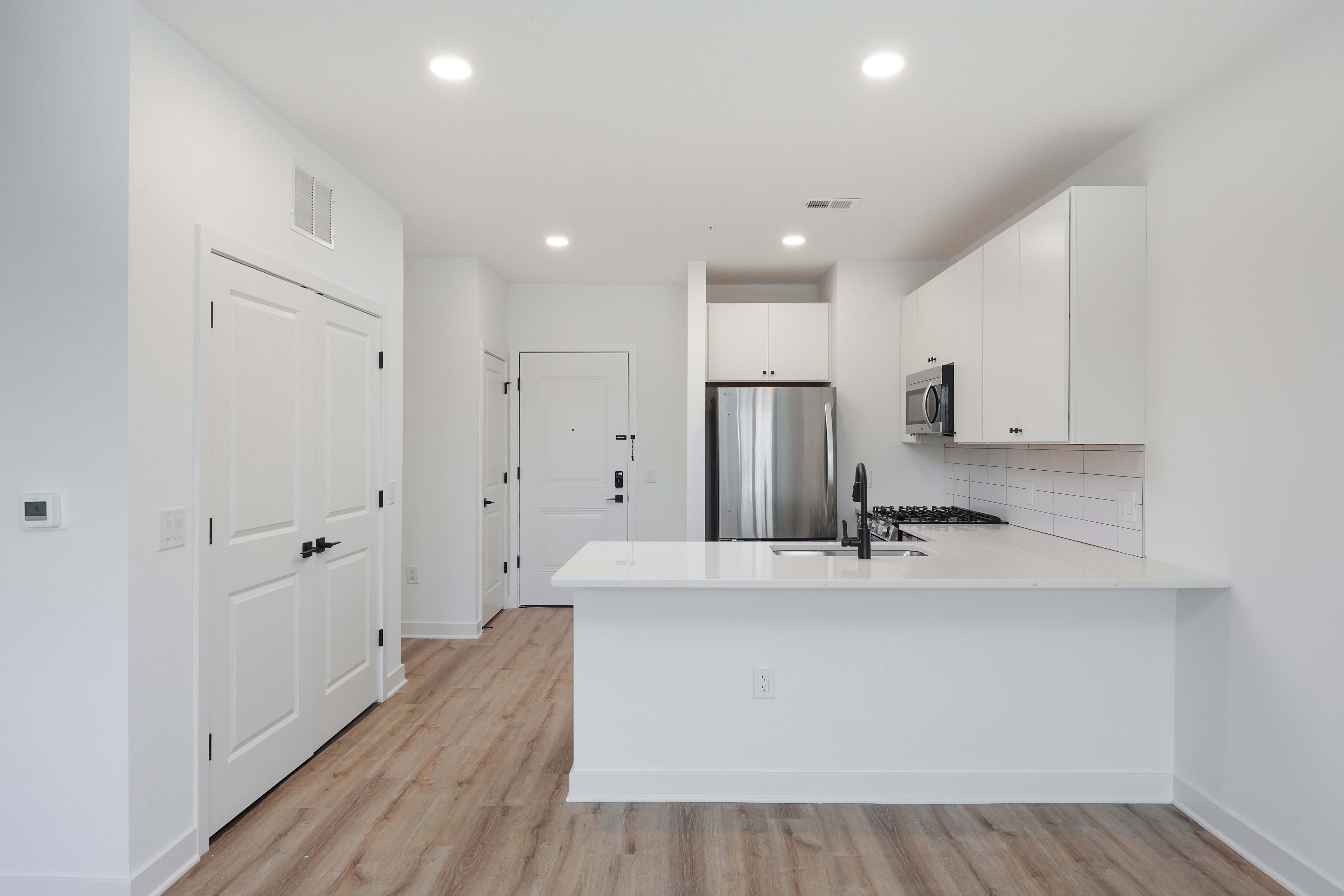 Modern kitchen and entryway in a studio apartment at The Arthur Carteret NJ