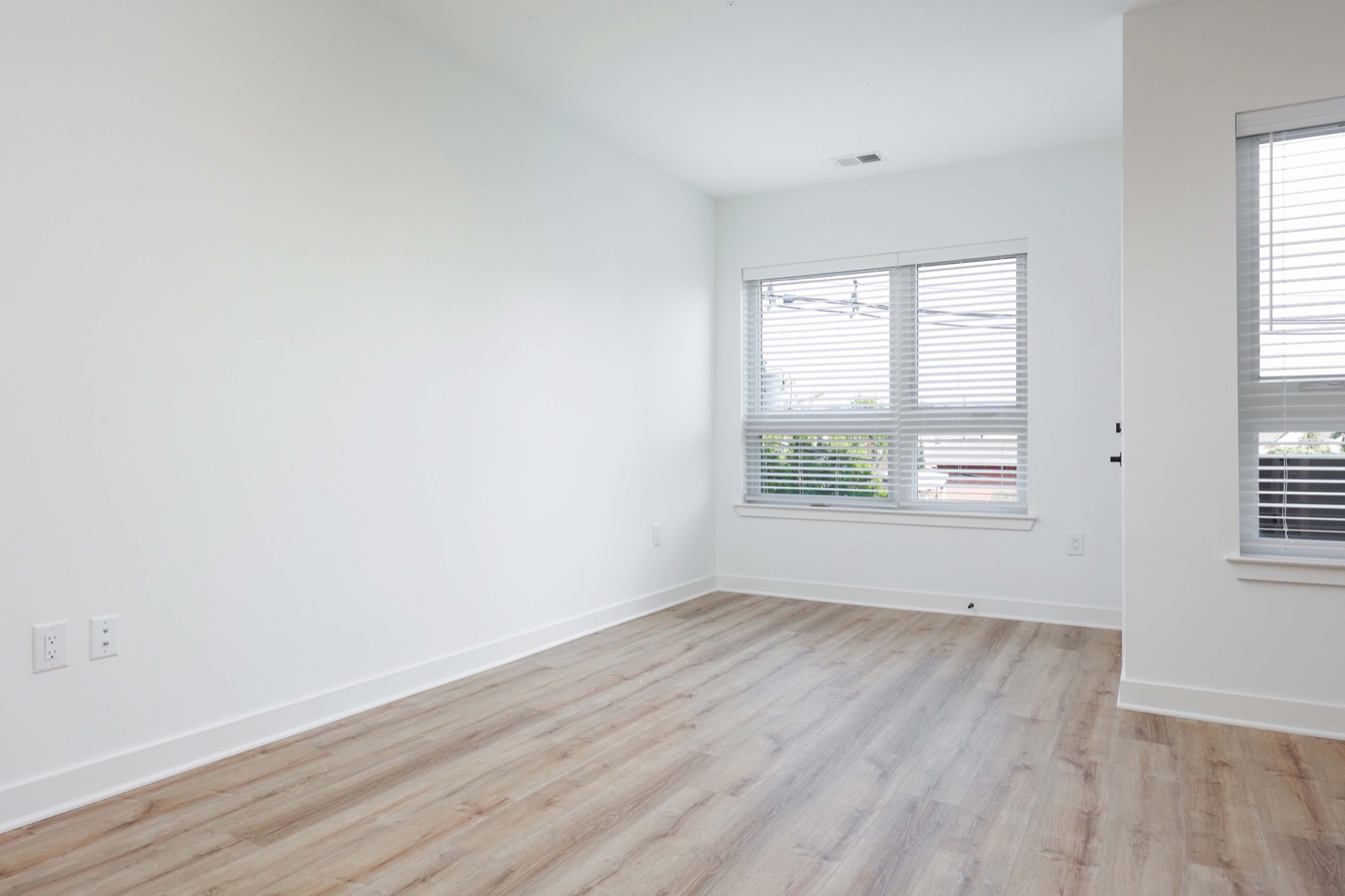 Spacious sleeping area with hardwood floors in a studio at The Arthur Carteret NJ